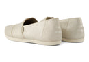 A women's Toms Alpargata slip-on shoe with a champagne metallic suede upper and a beige canvas footbed.