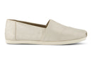 A women's Toms Alpargata slip-on shoe with a champagne metallic suede upper and a beige canvas footbed.