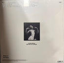 Vinyl record sleeve with black and white photo of a woman and text on a beige background