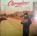 Album cover art for Clairaudience, featuring a person in a dark coat and beanie holding a cardboard sign that reads 'BERLIN FOR ALL' on a city street. The band name 'Clairaudience' is written in red script at the top.