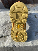 Gold shoe sole with 'GripTek' branding on a stone surface