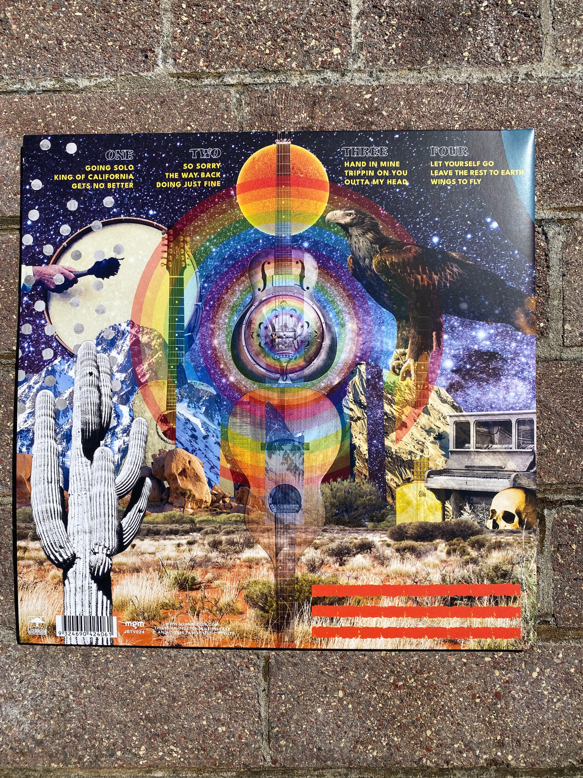 Colorful album cover with abstract design on a textured surface