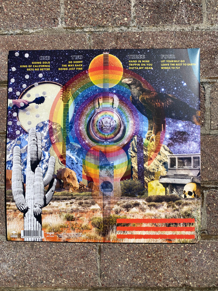 Colorful album cover with abstract design on a textured surface