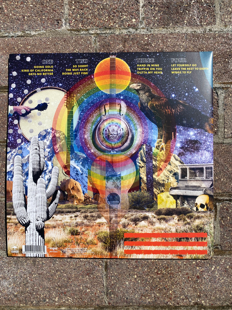 Colorful album cover with abstract design on a textured surface