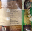 The back cover of the Joan Jett and the Blackhearts album 'A B A' on CD, showing the tracklist, barcode, and printed artwork with a brown textured background and green accents.