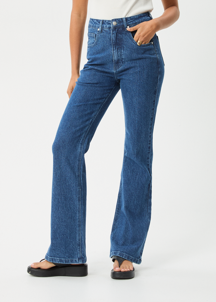 Person wearing blue jeans on a white background