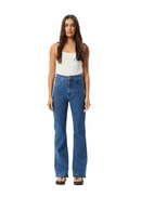 Woman wearing blue jeans and a white top on a white background