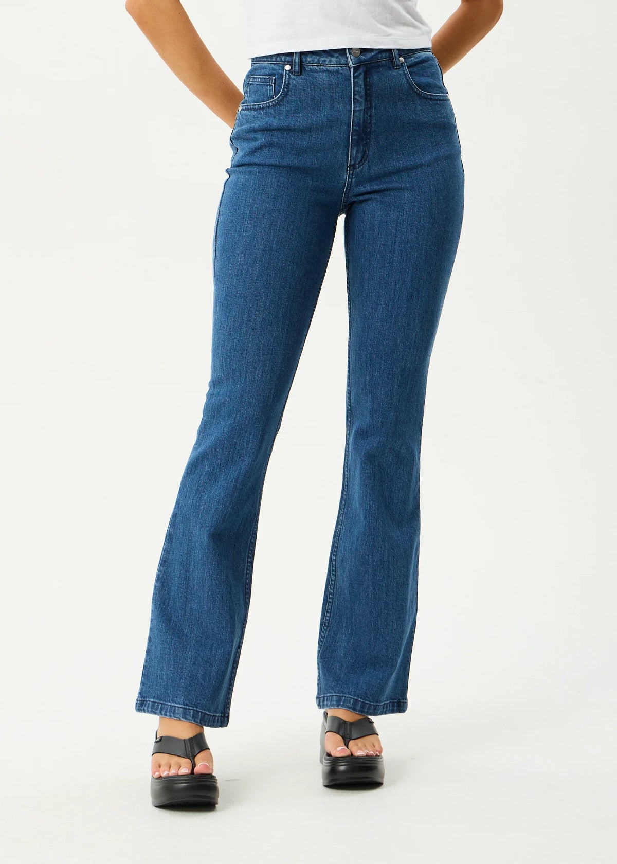 Person wearing blue jeans on a white background