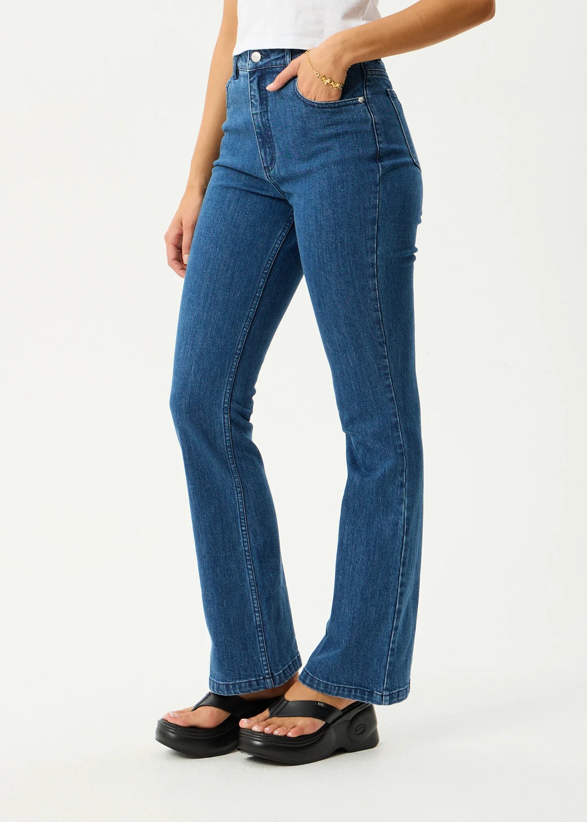 Person wearing blue jeans on a white background