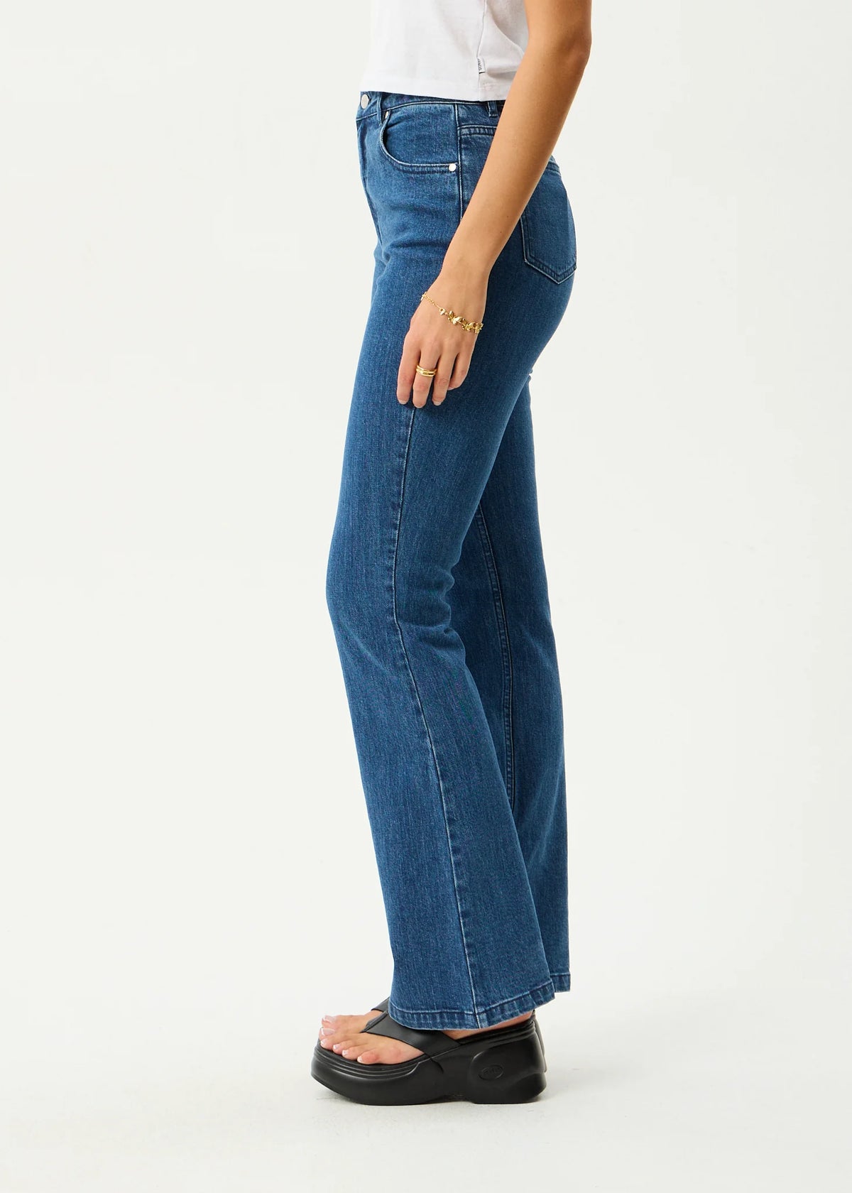 Person wearing blue jeans on a white background