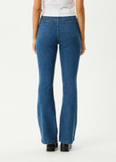 Person wearing blue jeans on a white background