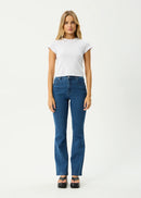 Woman wearing a white t-shirt and blue jeans on a white background