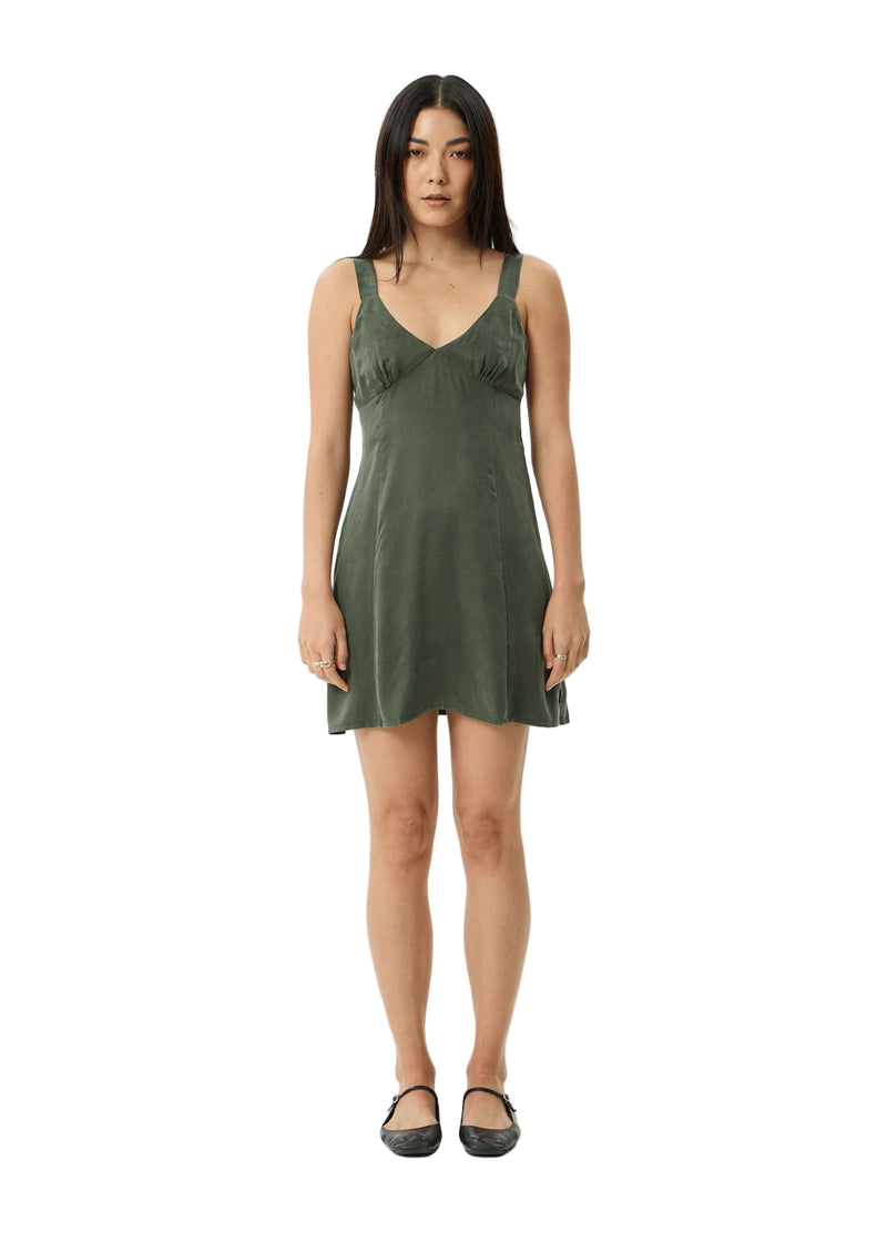 Woman wearing a green dress on a white background