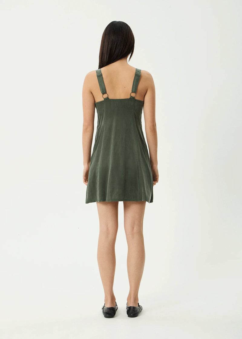Woman wearing a green dress on a white background