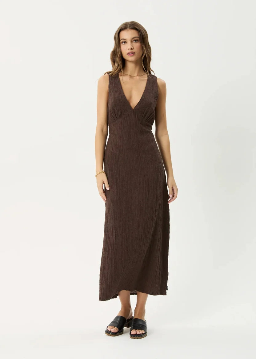 Woman wearing a brown sleeveless dress on a white background