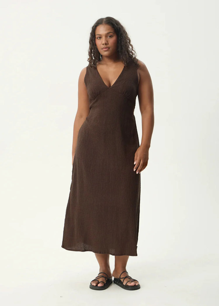 Woman wearing a brown sleeveless dress on a white background