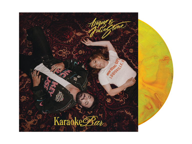 Vinyl record album cover for 'Karaoke Bar' by August the Gitboyz, featuring a dark patterned rug background with two people lying down, alongside a yellow-to-orange marbled vinyl disc.