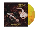 Vinyl record album cover for 'Karaoke Bar' by August the Gitboyz, featuring a dark patterned rug background with two people lying down, alongside a yellow-to-orange marbled vinyl disc.