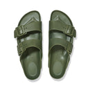 Pair of green sandals with buckles on a white background