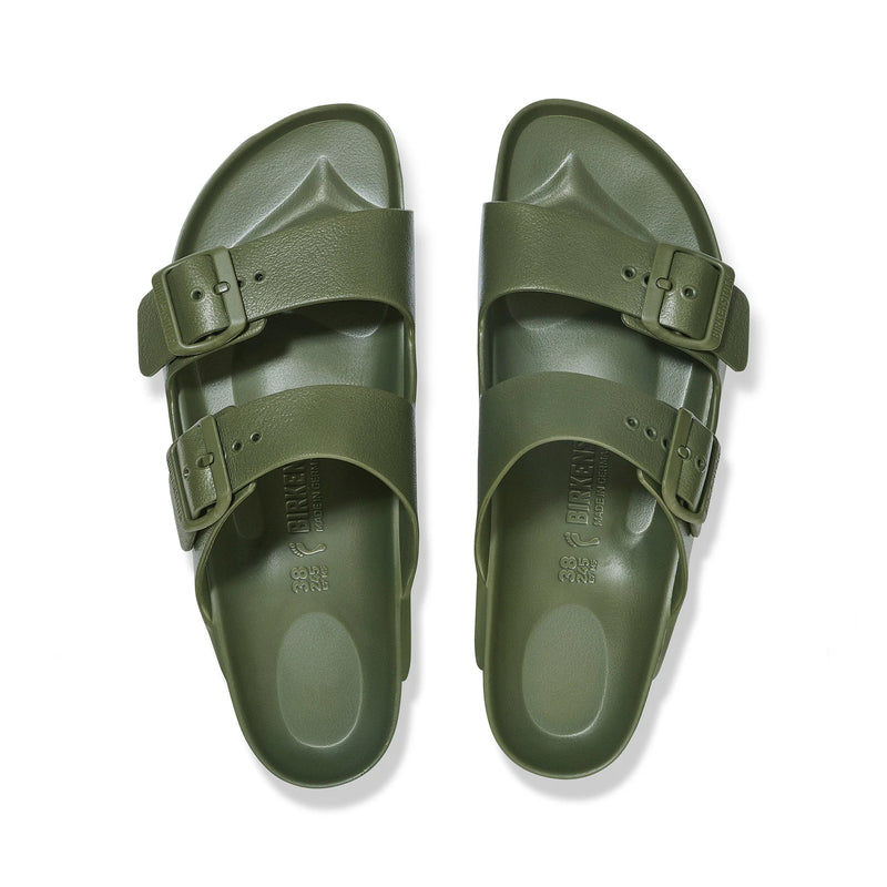 Pair of green sandals with buckles on a white background