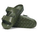 Green sandal with textured sole on a white background