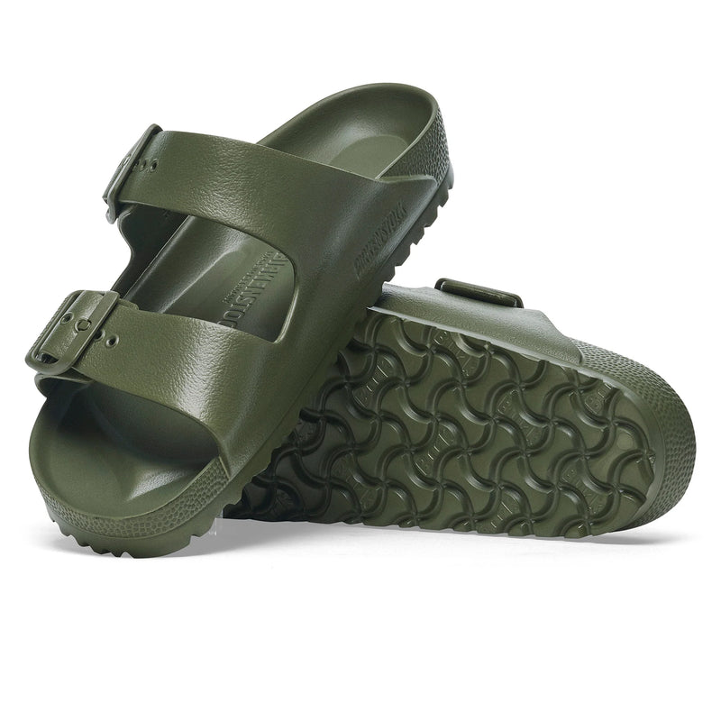 Green sandal with textured sole on a white background