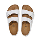 White sandals with brown soles on a white background