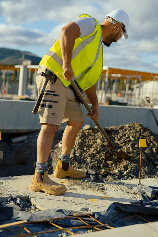A pair of Blundstone 9000 Unisex RotoFlex Safety Boots in wheat color with elastic-sided design, steel toe cap, and rubber outsole.
