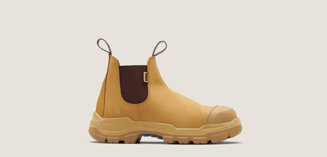 A pair of Blundstone 9000 Unisex RotoFlex Safety Boots in wheat color with elastic-sided design, steel toe cap, and rubber outsole.