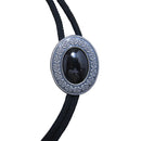 Black bolo tie with decorative silver and black pendant on a gray background