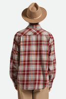 Person wearing a red and white plaid shirt with a brown hat on a light gray background