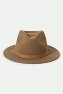 Brown fedora hat with band on a light beige background