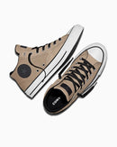 Pair of beige Converse sneakers on a white background