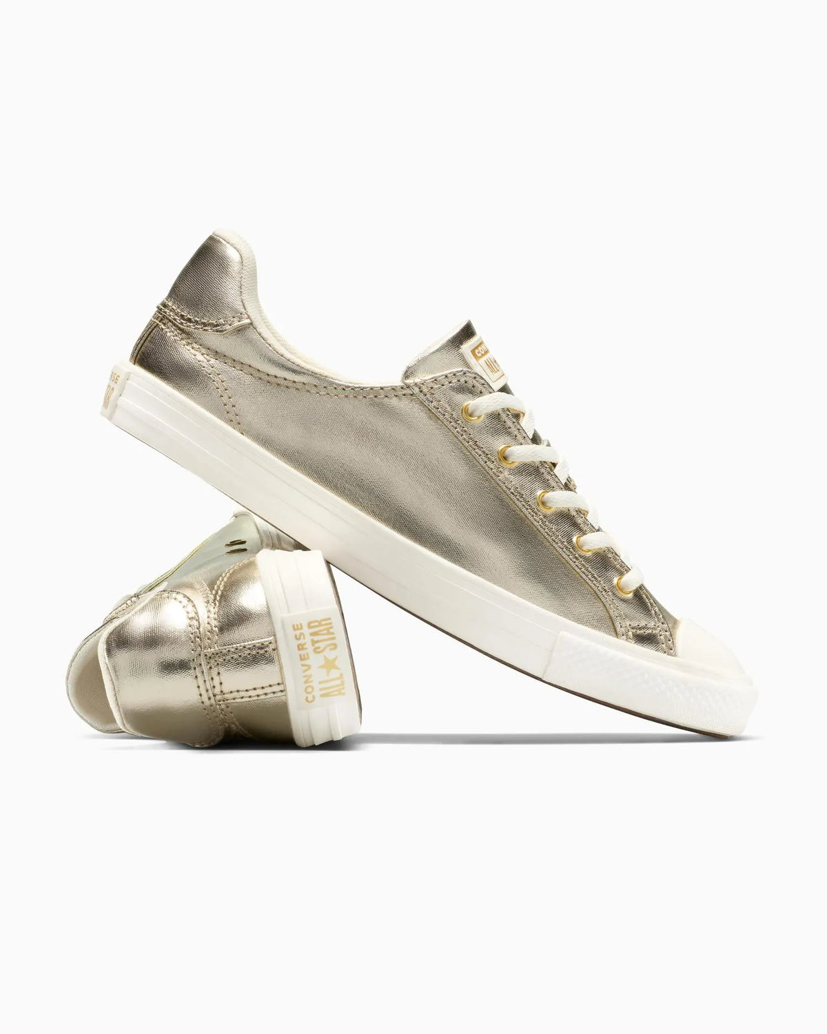 Pair of metallic gold sneakers with white soles on a white background