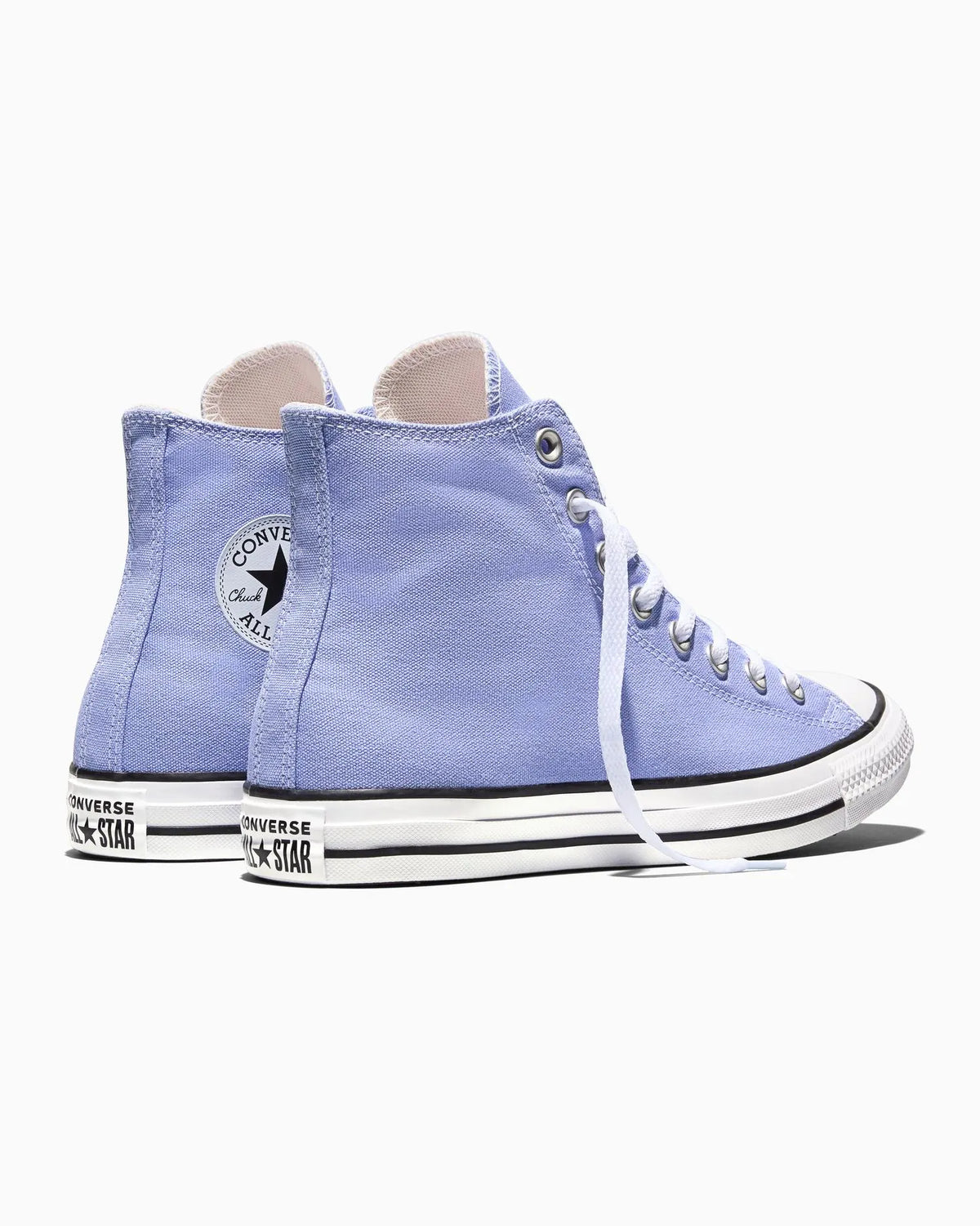 Pair of light blue Converse All Star high-top sneakers on a white background