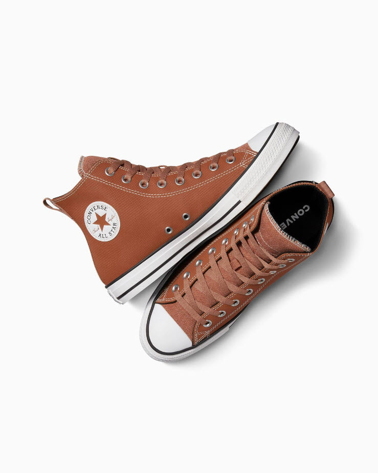 A pair of high-top Converse Chuck Taylor All Star Tec-Tuff sneakers in brown color with the distinctive block stitch upper and the Converse logo on the side.