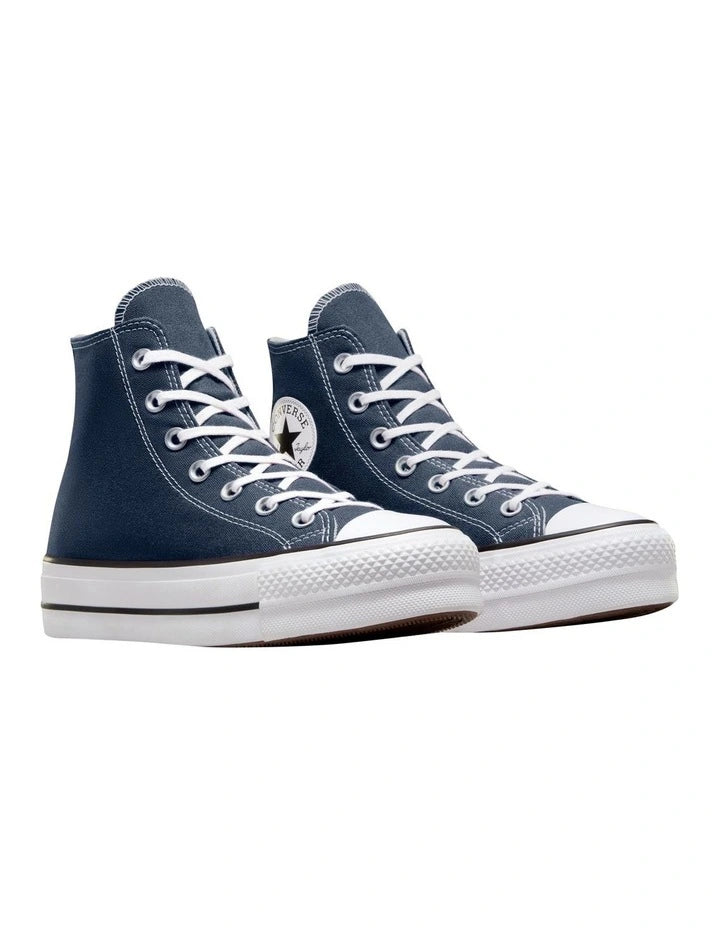 Navy high-top sneakers with white laces on a white background