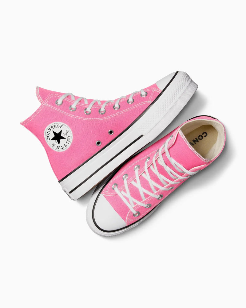 Pink high-top converse shoes on a white background