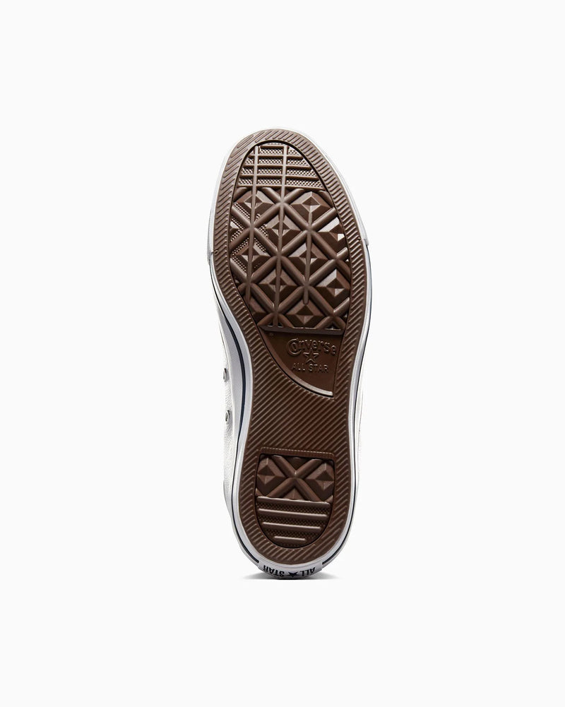 Close-up of a shoe sole with brand logo on a white background