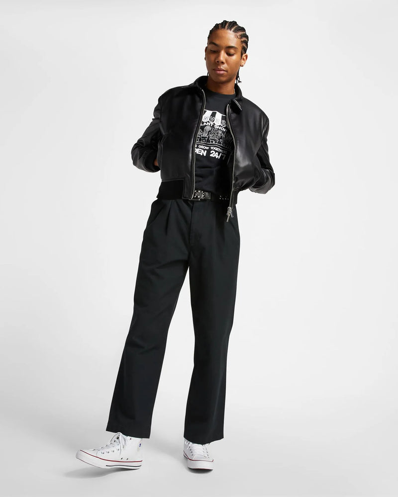 Person wearing a black outfit with a jacket and pants on a white background