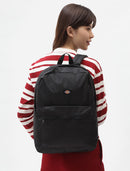 Person wearing a black backpack with a red and white striped shirt on a white background