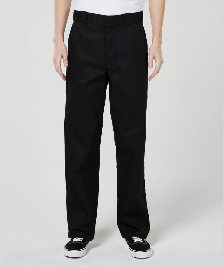 Person wearing black Dickies pants on a white background
