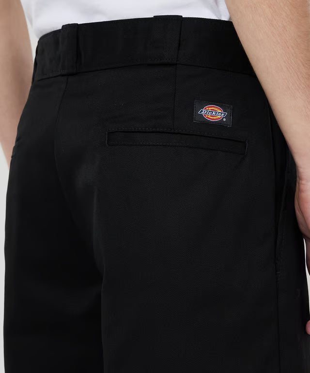 Black Dickies pants worn by a person on a white background