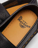 Close-up of a Dr. Martens adrian loafer shoes with a focus on the brand logo on the insole.
