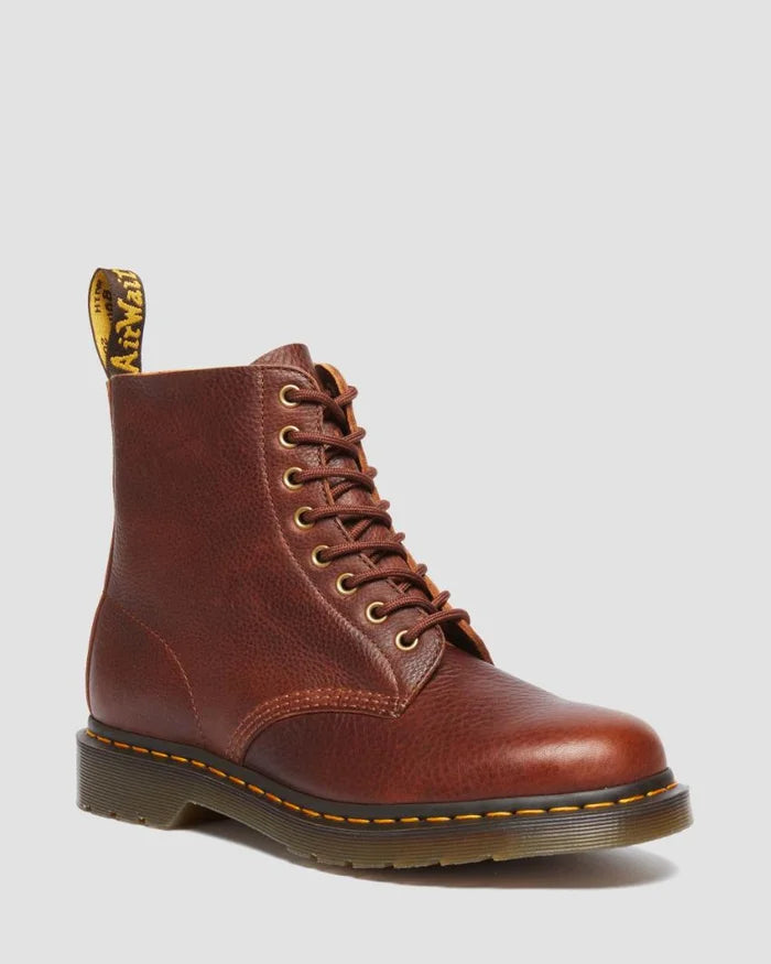 Brown leather boot with laces on a light gray background