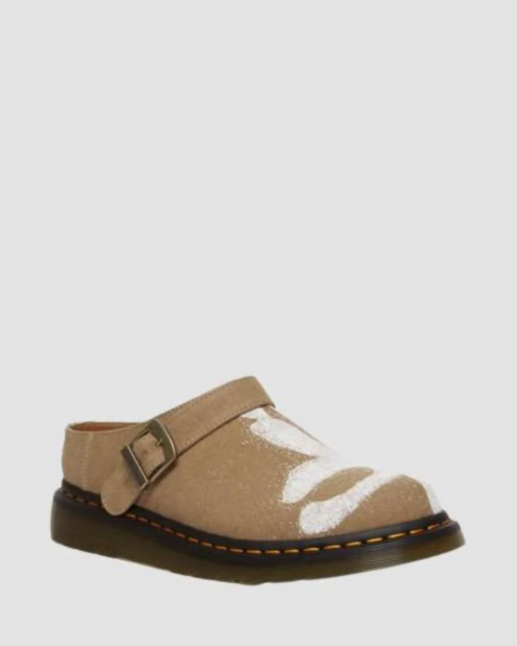 A pair of Dr Martens Archive Isham slip-on mules for women, featuring a hemp canvas vegan material in Savannah tan color with a floral print, antique gold hardware, and a Shore sole with yellow welt stitching.