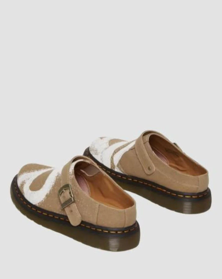 A pair of Dr Martens Archive Isham slip-on mules for women, featuring a hemp canvas vegan material in Savannah tan color with a floral print, antique gold hardware, and a Shore sole with yellow welt stitching.