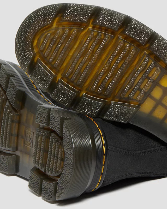 Close-up of black shoes with textured sole on a light gray background
