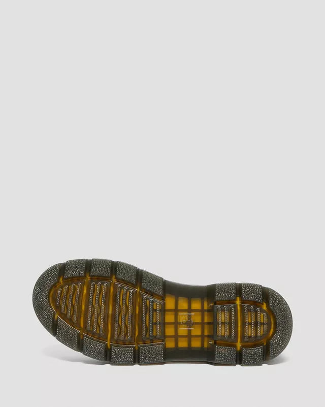 Close-up of a shoe sole with a textured pattern on a light gray background