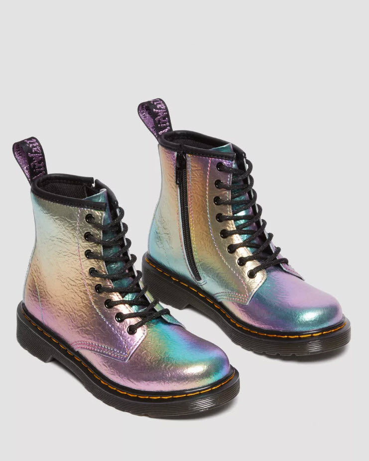 A pair of Dr Martens Infant 1460 Rainbow leather lace-up boots with a metallic multicolor finish and yellow stitching.